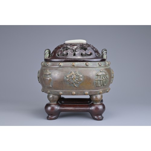 59 - A CHINESE BRONZE BAJIXIANG CENSER AND COVER. Of drum shape with raised rope twist handles on four le... 