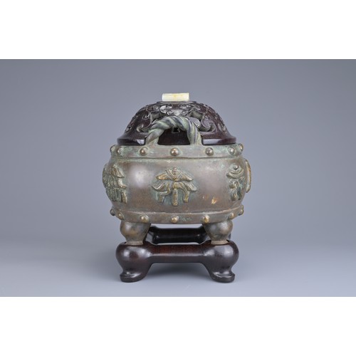 59 - A CHINESE BRONZE BAJIXIANG CENSER AND COVER. Of drum shape with raised rope twist handles on four le... 