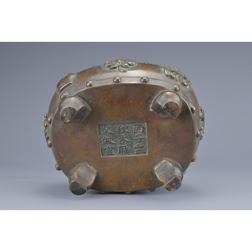 59 - A CHINESE BRONZE BAJIXIANG CENSER AND COVER. Of drum shape with raised rope twist handles on four le... 