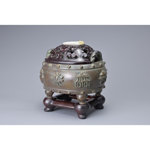 59 - A CHINESE BRONZE BAJIXIANG CENSER AND COVER. Of drum shape with raised rope twist handles on four le... 