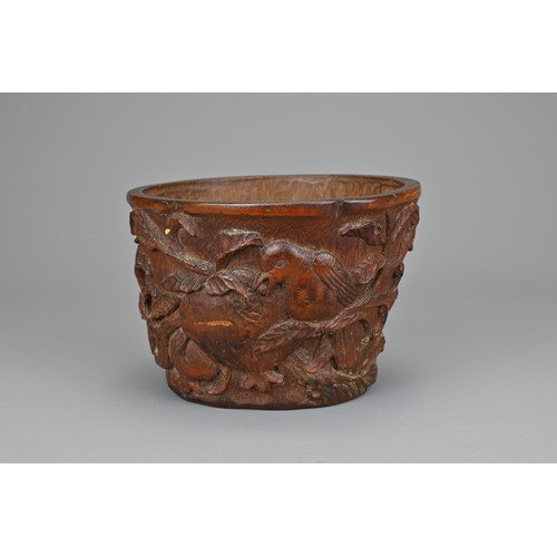 61 - A CHINESE CARVED BAMBOO LIBATION CUP, 17/18TH CENTURY. Carved in relief with bird eating pomegranate... 