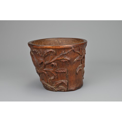 61 - A CHINESE CARVED BAMBOO LIBATION CUP, 17/18TH CENTURY. Carved in relief with bird eating pomegranate... 