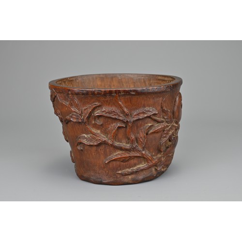 61 - A CHINESE CARVED BAMBOO LIBATION CUP, 17/18TH CENTURY. Carved in relief with bird eating pomegranate... 