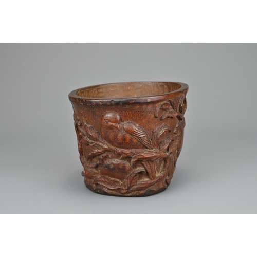 61 - A CHINESE CARVED BAMBOO LIBATION CUP, 17/18TH CENTURY. Carved in relief with bird eating pomegranate... 