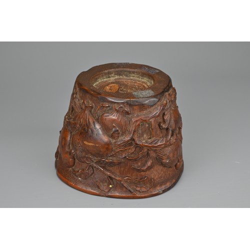 61 - A CHINESE CARVED BAMBOO LIBATION CUP, 17/18TH CENTURY. Carved in relief with bird eating pomegranate... 