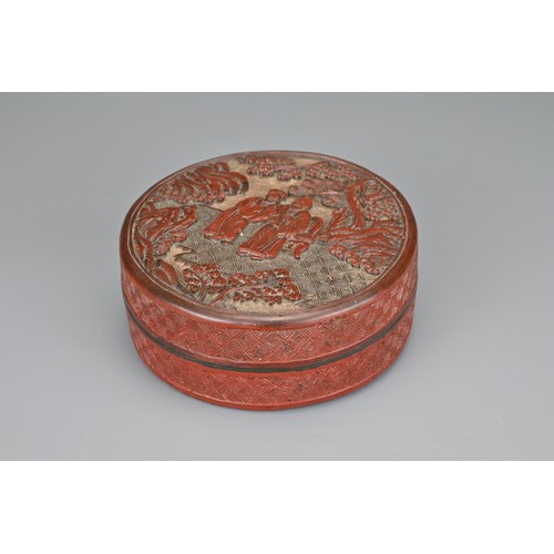 62 - A CHINESE CINNABAR LACQUER INK BOX AND COVER, QING DYNASTY. Of cylindrical form carved with scholars... 