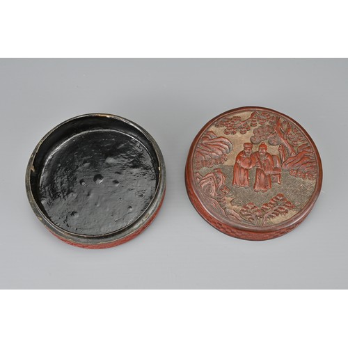 62 - A CHINESE CINNABAR LACQUER INK BOX AND COVER, QING DYNASTY. Of cylindrical form carved with scholars... 