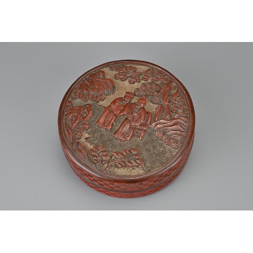 62 - A CHINESE CINNABAR LACQUER INK BOX AND COVER, QING DYNASTY. Of cylindrical form carved with scholars... 