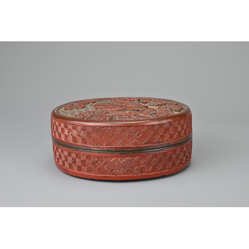 62 - A CHINESE CINNABAR LACQUER INK BOX AND COVER, QING DYNASTY. Of cylindrical form carved with scholars... 