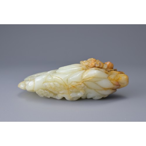 60 - A CHINESE PALE CELADON AND RUSSET JADE CARVING. Depicting two cranes on a rock formation with pine t... 