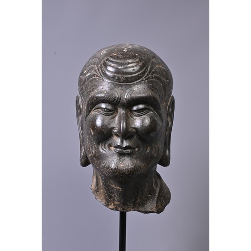 192 - A CHINESE CARVED STONE HEAD OF LUOHAN. Dark heavy grey stone with well carved features, deep lines t... 