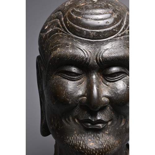 192 - A CHINESE CARVED STONE HEAD OF LUOHAN. Dark heavy grey stone with well carved features, deep lines t... 