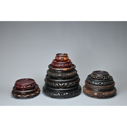 11 - A QUANTITY OF CHINESE CARVED WOOD DISPLAY STANDS. Ten stands each or circular form in various sizes ... 