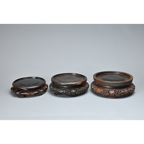 11 - A QUANTITY OF CHINESE CARVED WOOD DISPLAY STANDS. Ten stands each or circular form in various sizes ... 