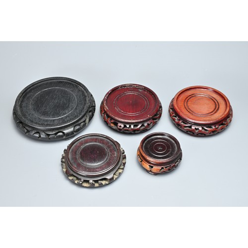 11 - A QUANTITY OF CHINESE CARVED WOOD DISPLAY STANDS. Ten stands each or circular form in various sizes ... 