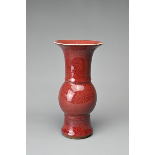 13 - A CHINESE SANG-DE-BOEUF PORCELAIN GU-FORM BEAKER VASE. Covered in a dark red speckled glaze thinning... 