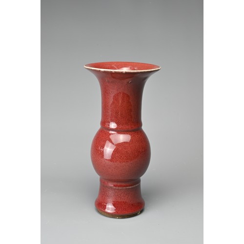 13 - A CHINESE SANG-DE-BOEUF PORCELAIN GU-FORM BEAKER VASE. Covered in a dark red speckled glaze thinning... 