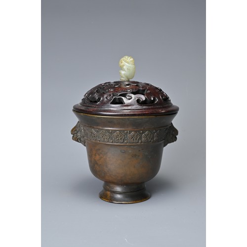 44 - A CHINESE BRONZE CENSER AND COVER. In the form of a cup with lion mask handles and band of floral de... 