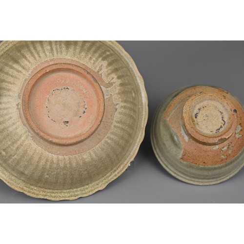 104 - TWO SOUTH EAST ASIAN CELADON POTTERY ITEMS, 14/15TH CENTURY. To include a bowl with bracket lobed ri... 