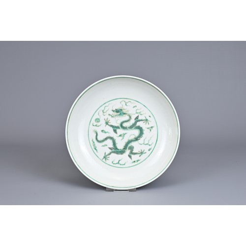 2 - A CHINESE PORCELAIN DRAGON DISH, EARLY 20TH CENTURY. Decorated in green enamel with a dragon chasing... 