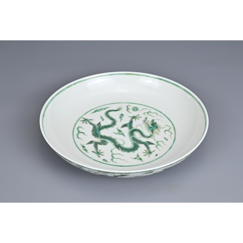 2 - A CHINESE PORCELAIN DRAGON DISH, EARLY 20TH CENTURY. Decorated in green enamel with a dragon chasing... 