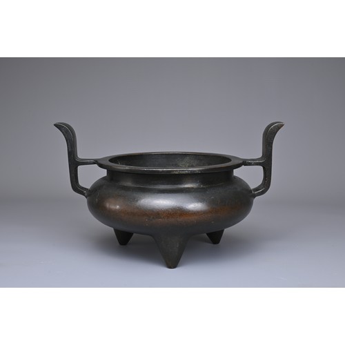 24 - A CHINESE BRONZE TRIPOD CENSER, YU TANG QING WAN MARK. Circular form on three coned feet with raised... 