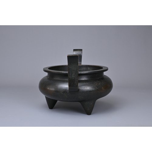 24 - A CHINESE BRONZE TRIPOD CENSER, YU TANG QING WAN MARK. Circular form on three coned feet with raised... 