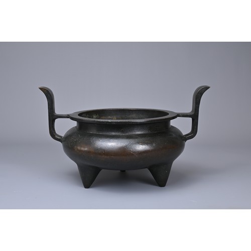 24 - A CHINESE BRONZE TRIPOD CENSER, YU TANG QING WAN MARK. Circular form on three coned feet with raised... 