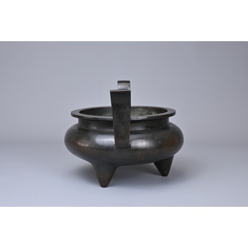 24 - A CHINESE BRONZE TRIPOD CENSER, YU TANG QING WAN MARK. Circular form on three coned feet with raised... 