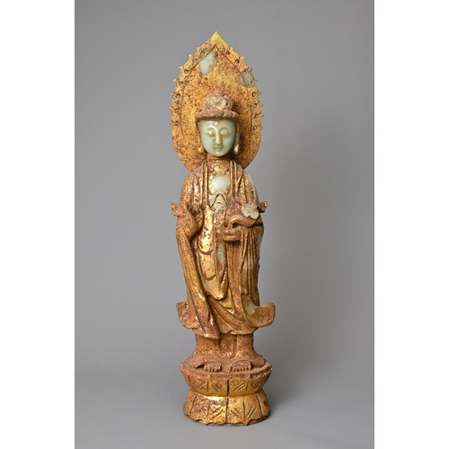 95 - A CHINESE GILT DECORATED CELADON JADE FIGURE OF GUANYIN. The God of Mercy with mandorla standing dre... 