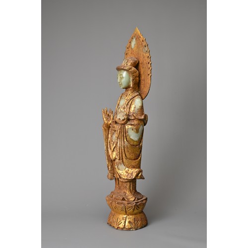 95 - A CHINESE GILT DECORATED CELADON JADE FIGURE OF GUANYIN. The God of Mercy with mandorla standing dre... 