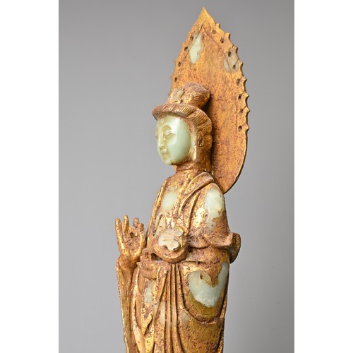 95 - A CHINESE GILT DECORATED CELADON JADE FIGURE OF GUANYIN. The God of Mercy with mandorla standing dre... 