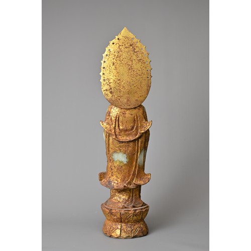 95 - A CHINESE GILT DECORATED CELADON JADE FIGURE OF GUANYIN. The God of Mercy with mandorla standing dre... 