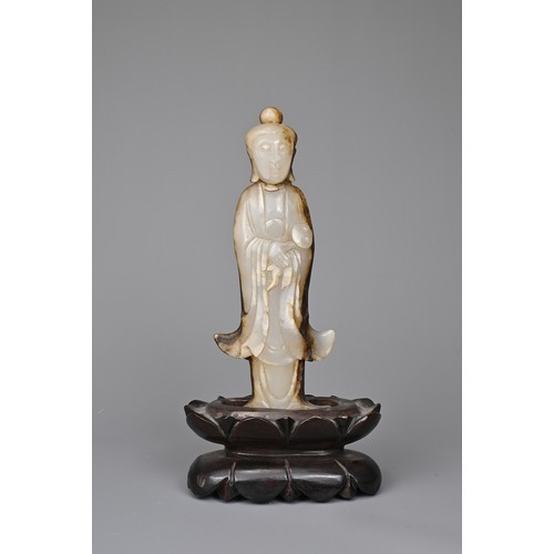 39 - A CHINESE AGATE CARVING OF A STANDING BUDDHA, QING DYNASTY. The figure standing in flowing robes hol... 