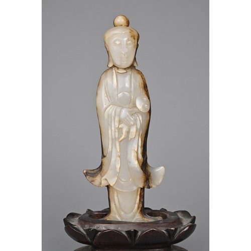 39 - A CHINESE AGATE CARVING OF A STANDING BUDDHA, QING DYNASTY. The figure standing in flowing robes hol... 