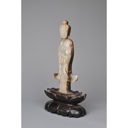 39 - A CHINESE AGATE CARVING OF A STANDING BUDDHA, QING DYNASTY. The figure standing in flowing robes hol... 