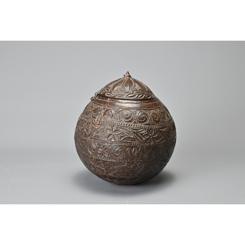 42 - AN ANGLO INDIAN CARVED COCONUT TEA CADDY, 19/20TH CENTURY. With bands of floral decoration in relief... 