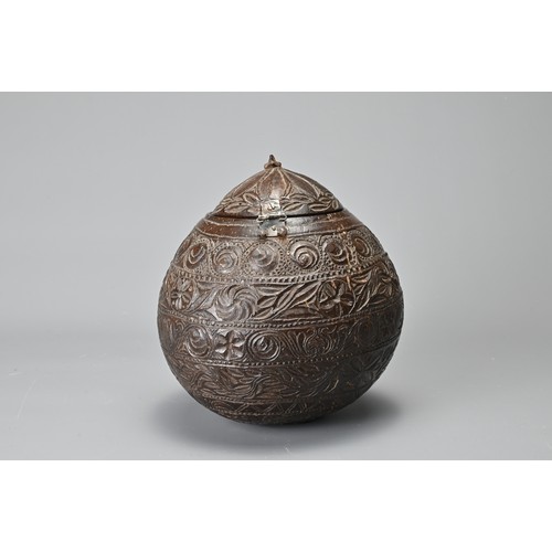 42 - AN ANGLO INDIAN CARVED COCONUT TEA CADDY, 19/20TH CENTURY. With bands of floral decoration in relief... 