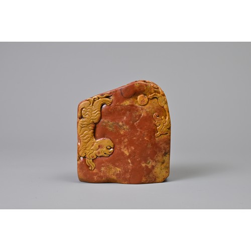 84 - A CHINESE CARVED SOAPSTONE SEAL, QING DYNASTY. Orange and red tones of boulder form carved in relief... 