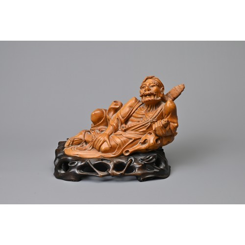 83 - A JAPANESE CARVED BOXWOOD FIGURE ON STAND, 19TH CENTURY. Well carved depicting a man wearing one rop... 