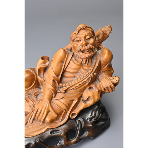 83 - A JAPANESE CARVED BOXWOOD FIGURE ON STAND, 19TH CENTURY. Well carved depicting a man wearing one rop... 