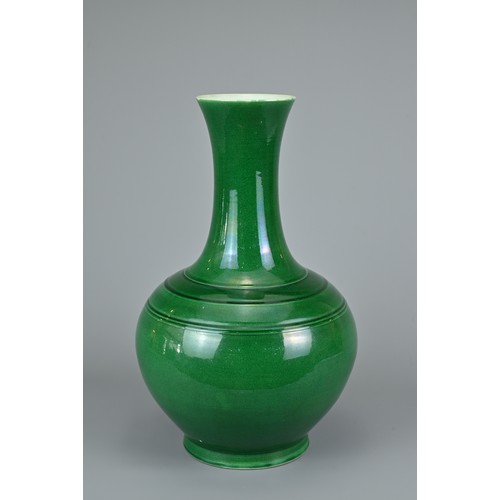 73 - A CHINESE GREEN GLAZED BOTTLE VASE, 20TH CENTURY. Globular body with tall tapered neck decorated wit... 