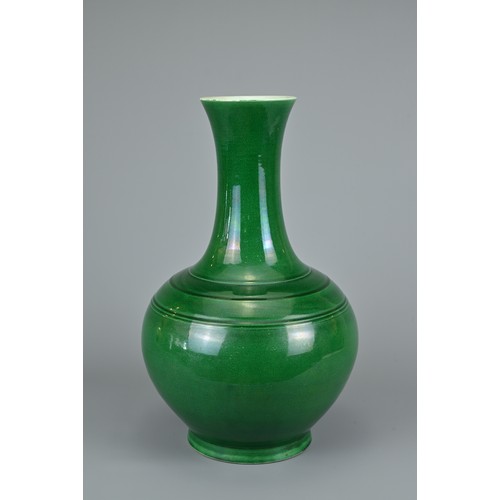 73 - A CHINESE GREEN GLAZED BOTTLE VASE, 20TH CENTURY. Globular body with tall tapered neck decorated wit... 