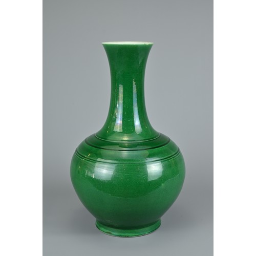 73 - A CHINESE GREEN GLAZED BOTTLE VASE, 20TH CENTURY. Globular body with tall tapered neck decorated wit... 