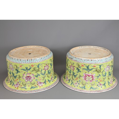 81 - A LARGE PAIR OF CHINESE LIME GREEN GROUND FAMILLE ROSE PORCELAIN JARDINIERES. Of cylindrical form wi... 