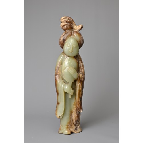 91 - A CHINESE CELADON JADE FIGURE OF A LADY HOLDING A FAN. Dressed in a long robe with hair tied up clas... 