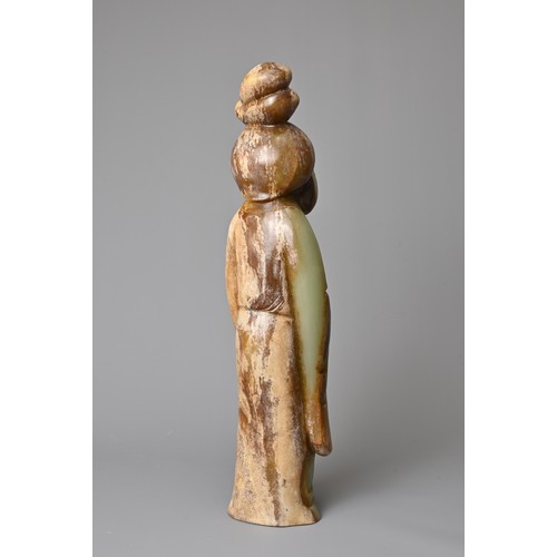 91 - A CHINESE CELADON JADE FIGURE OF A LADY HOLDING A FAN. Dressed in a long robe with hair tied up clas... 