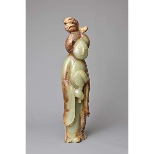 91 - A CHINESE CELADON JADE FIGURE OF A LADY HOLDING A FAN. Dressed in a long robe with hair tied up clas... 