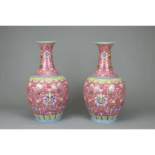 28 - A PAIR OF CHINESE RUBY GROUND PORCELAIN VASES, DAOGUANG MARK. Decorated in famille rose enamels with... 