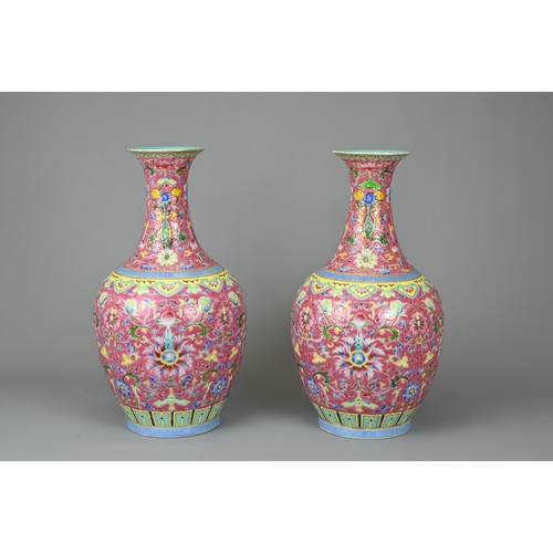 28 - A PAIR OF CHINESE RUBY GROUND PORCELAIN VASES, DAOGUANG MARK. Decorated in famille rose enamels with... 